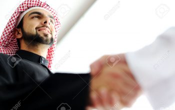 20133325-successful-arabic-business-people-shaking-hands-over-a-deal-stock-photo