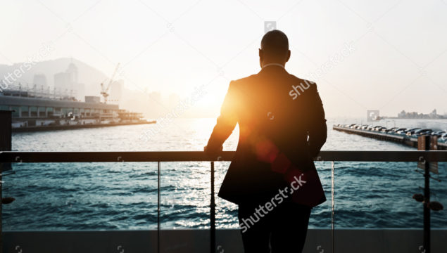 stock-photo-back-view-of-male-successful-entrepreneur-enjoying-evening-sunset-while-standing-outdoors-in-marina-390163987